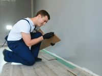 man-laying-laminate-flooring-in-construction-concept.jpg