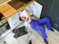 young-plumber-or-technician-installing-or-repairing-system-of-water-filtration.jpg
